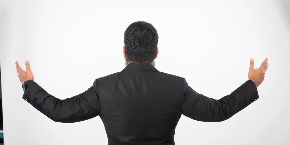 Abdul Lathif facing the audience, arms open