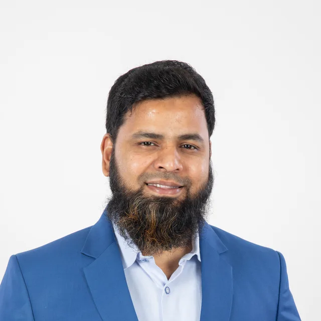 Abdul Lathif in a blue suit, smiling