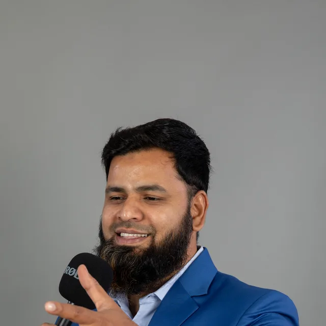 Abdul Lathif in conversation, microphone in hand